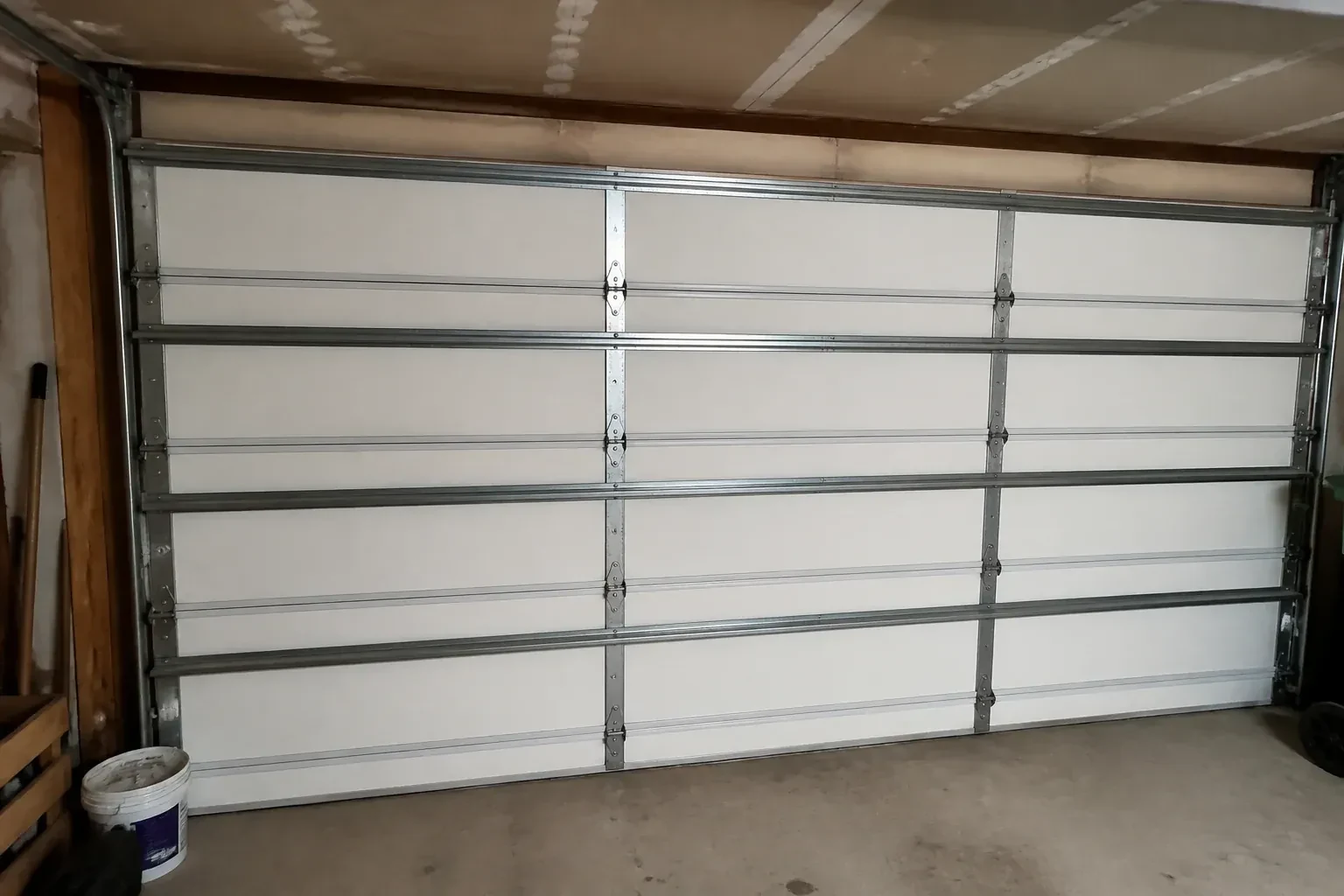 Interior of a closed sectional door with horizontal metal reinforcement struts. — Wind-Rated Garage Door Replacement, Vaughan